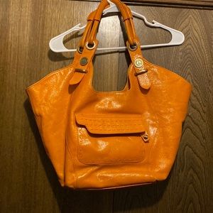 Donald Pliner orange purse. Some wear as shown in pictures